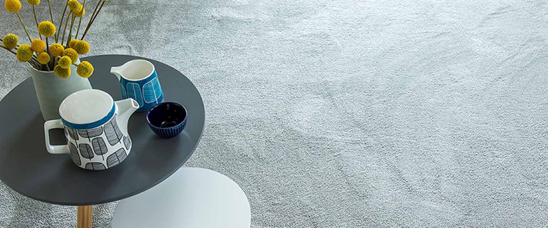 Light grey carpet with coffee table